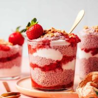 Jars of our strawberries and cream chia pudding with layers of compote and yogurt