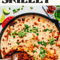 Overhead photo of a cast iron pan of our Cheesy Vegan Enchilada Skillet with text above that says ready in 30 minutes